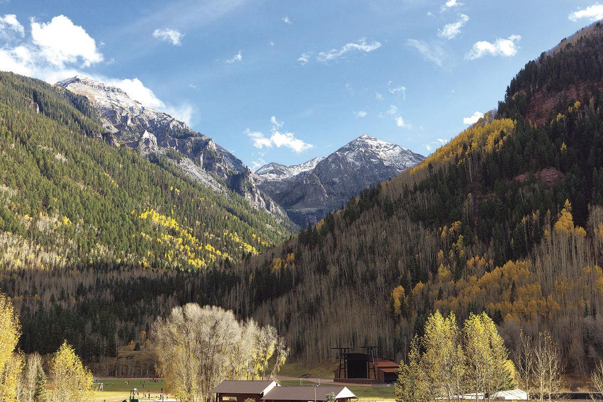 Autumn mountain valley with snow-capped peaks